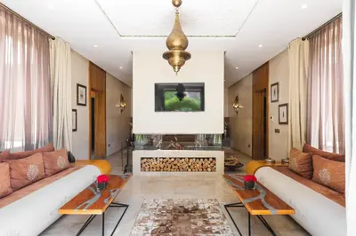 a living room with two couches and a fireplace at PL Place Boutique Hôtel & Restaurant in Marrakech