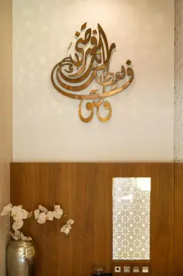 a sign on the wall of a room with flowers at PL Place Boutique Hôtel & Restaurant in Marrakech