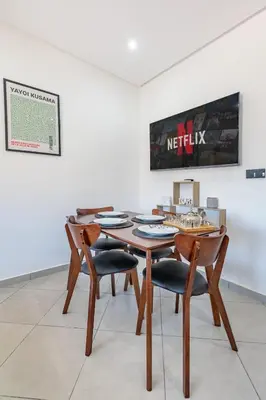 a dining room with a wooden table and chairs at Super apartment in marrrakech in Marrakech