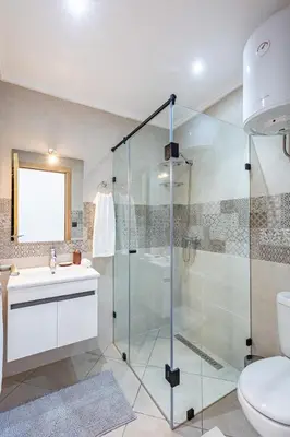 a bathroom with a glass shower and a sink at Super apartment in marrrakech in Marrakech