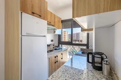 a kitchen with a white refrigerator and a large window at Super apartment in marrrakech in Marrakech