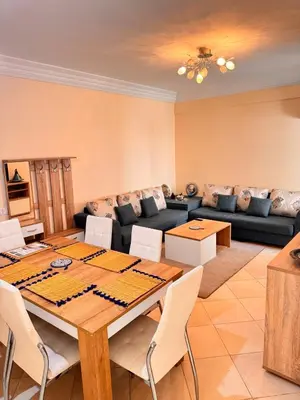 a living room with a table and a couch at Appartement Marrakech in Marrakech