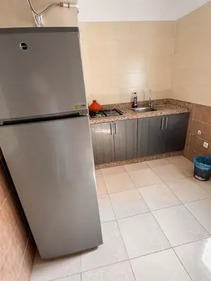a kitchen with a stainless steel refrigerator and a sink at Appartement Marrakech in Marrakech