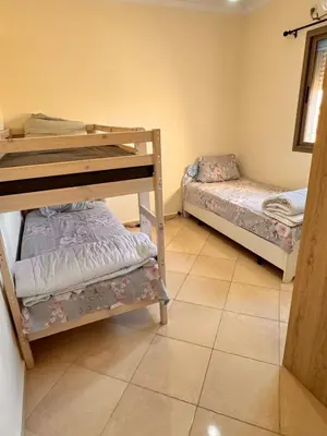 a room with two bunk beds and a tiled floor at Appartement Marrakech in Marrakech