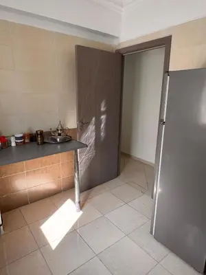 a kitchen with a sink and a counter and a door at Appartement Marrakech in Marrakech