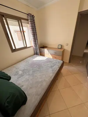 a bedroom with a large bed and a window at Appartement Marrakech in Marrakech