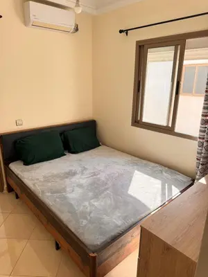 a bed in a room with a window at Appartement Marrakech in Marrakech
