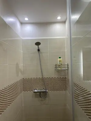 a shower with a glass door in a bathroom at Luxury Apartment Near Airport & Medina in Marrakech