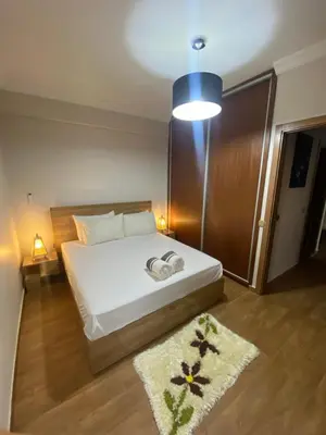 a bedroom with a white bed and a blue light at Luxury Apartment Near Airport & Medina in Marrakech