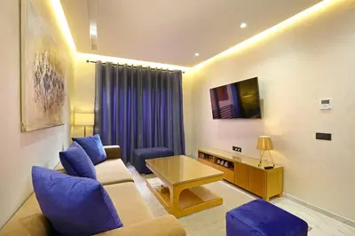 a living room with a couch and a table at Heart of City 2BR 2Patios Fiber AC Modern New Calm in Marrakech