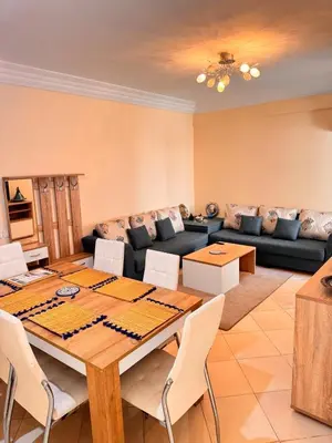 a living room with a table and a couch at Appartement sur Marrakech in Marrakech