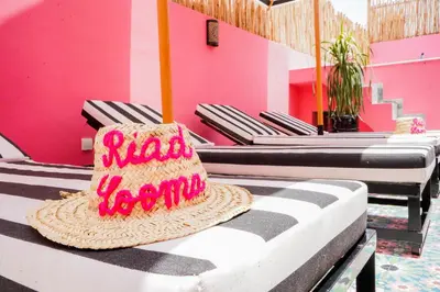 a straw hat sitting on a table in a restaurant at Riad Looma in Marrakech