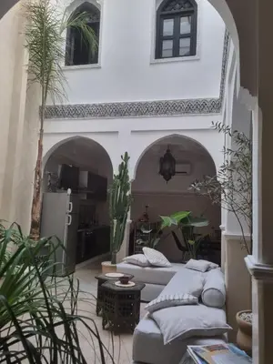 a living room with two couches and a table at Riad zouina in Marrakech