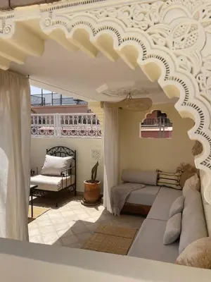 a living room with a bed and a ceiling at Riad zouina in Marrakech
