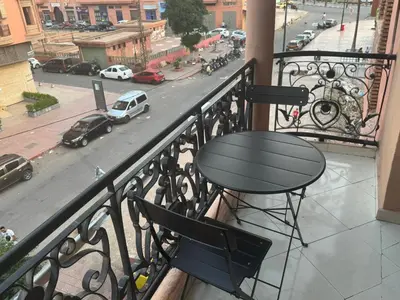 a table on a balcony with a view of a street at Elegant Apartment in Marrakech Gueliz in Marrakech