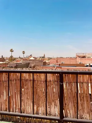 a wooden fence with a city in the background at Appartement cosy au coeur des souks de Marrakech in Marrakech