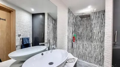 a bathroom with a white tub and a sink at Exceptional View & Hot Tub Marrakesh in Marrakech
