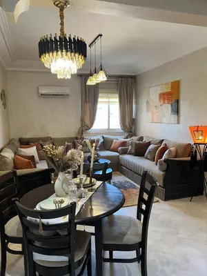 a living room with a table and a couch at Dar Mezhor apartment in Marrakech
