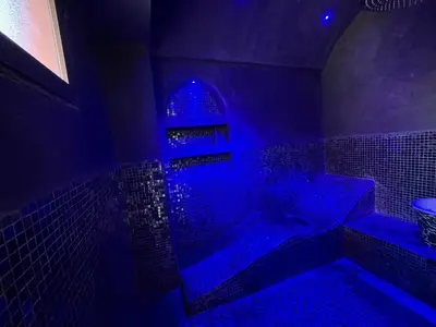a blue bathroom with a tub with blue lights at Villa palmeraie in Marrakech
