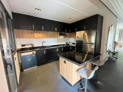 a kitchen with black cabinets and a black counter top at Villa palmeraie in Marrakech