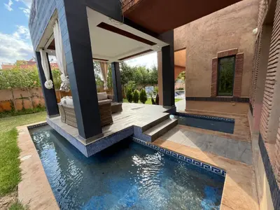 a swimming pool in the backyard of a house at Villa palmeraie in Marrakech