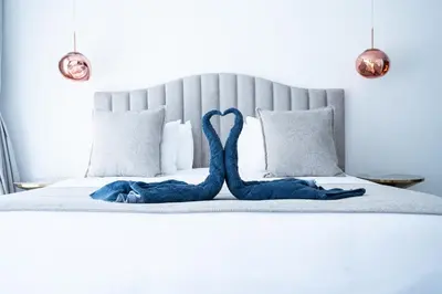 a bed with two blue mermaid towels on it at Modern Villa Selma in Marrakech