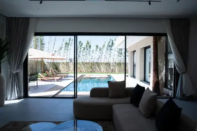 a living room with a couch and a pool at Modern Villa Selma in Marrakech