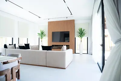 a white living room with a couch and a tv at Modern Villa Selma in Marrakech