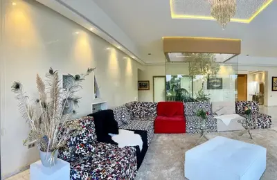 a living room with a couch and a red chair at Spacious Villa with Mountain Views - 550 m² in Marrakech
