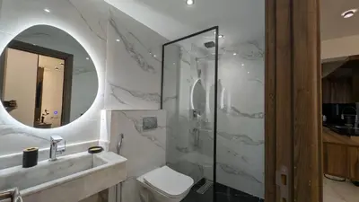 a bathroom with a toilet and a sink and a mirror at Stylish Apart Near City Center in Marrakech
