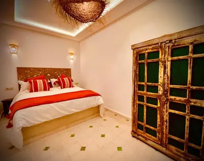 a bedroom with a bed and a large window at Riad Kimme Room 1 in Marrakech