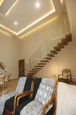 a living room with two beds and a staircase at Charming duplex appartment in Marrakech