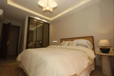a bedroom with a large white bed with a ceiling at Charming duplex appartment in Marrakech