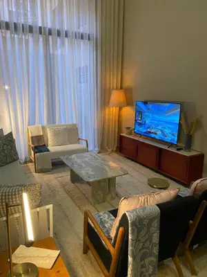a living room with a couch and a tv at Charming duplex appartment in Marrakech