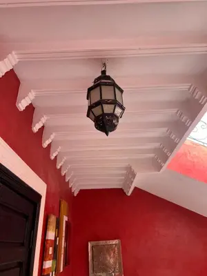 a light hanging from a ceiling in a room at Comfortable house with pool in Marrakech