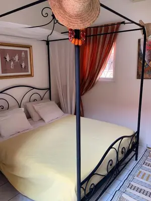 a bedroom with a black canopy bed in a room at Comfortable house with pool in Marrakech