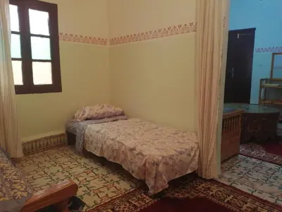 a bedroom with a bed and a window at Apartment 3 mins Place jamaa el fana in Marrakech