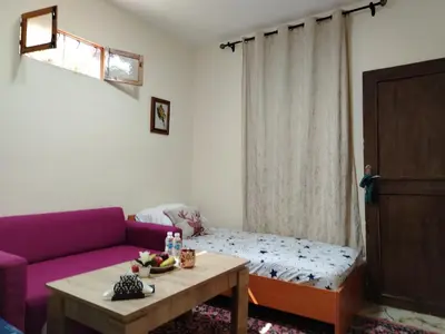 a living room with a purple couch and a table at غرفة مريحة و نضيفة in Marrakech