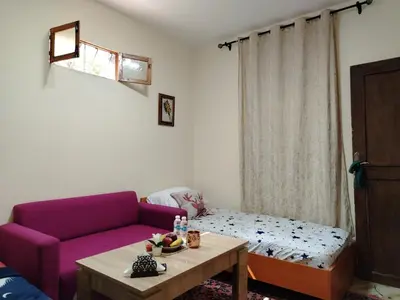 a living room with a purple couch and a table at غرفة مريحة و نضيفة in Marrakech