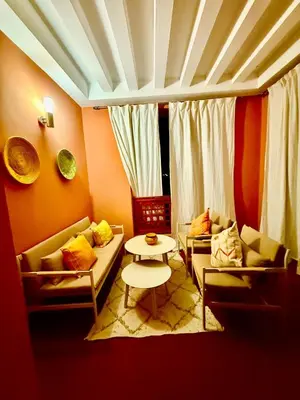 a living room with two couches and a table at appartement bel vue sur l'atlas in Marrakech