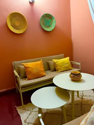 a living room with a couch and a table at appartement bel vue sur l'atlas in Marrakech