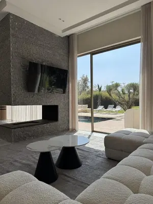 a living room with a couch and a table at Villa Maymouna in Marrakech