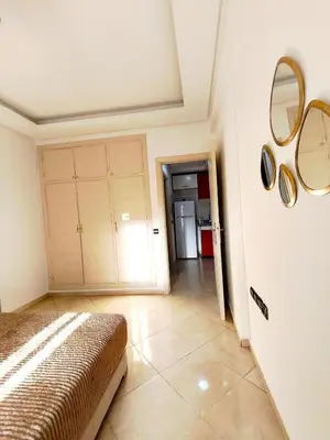 a bedroom with a bed and two mirrors on the wall at Appartement cosy Marrakech in Marrakech