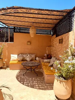 a patio with a couch and a table at Momo House- Riad Momo in Marrakech