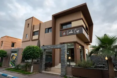 a building with a sign for a restaurant at Jawhar Appart A4 in Marrakech