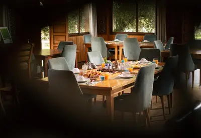 a dining room with tables and chairs with food on them at Maison safou in Marrakech