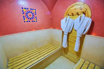 a sauna with a bench and a painting on the wall at Maison safou in Marrakech