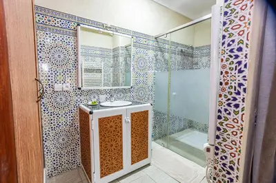 a bathroom with a sink and a shower at Maison safou in Marrakech
