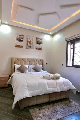 a bedroom with a large bed with white sheets at good Appartement Marrakech in Marrakech