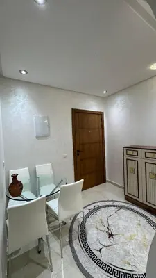 a dining room with a table and chairs and a door at Le Joyau de la Ville in Marrakech